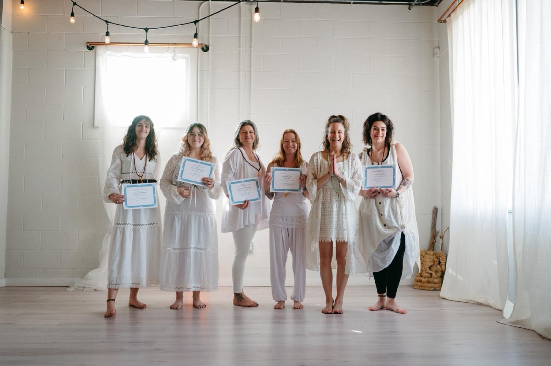 Yoga teacher training students celebrating together