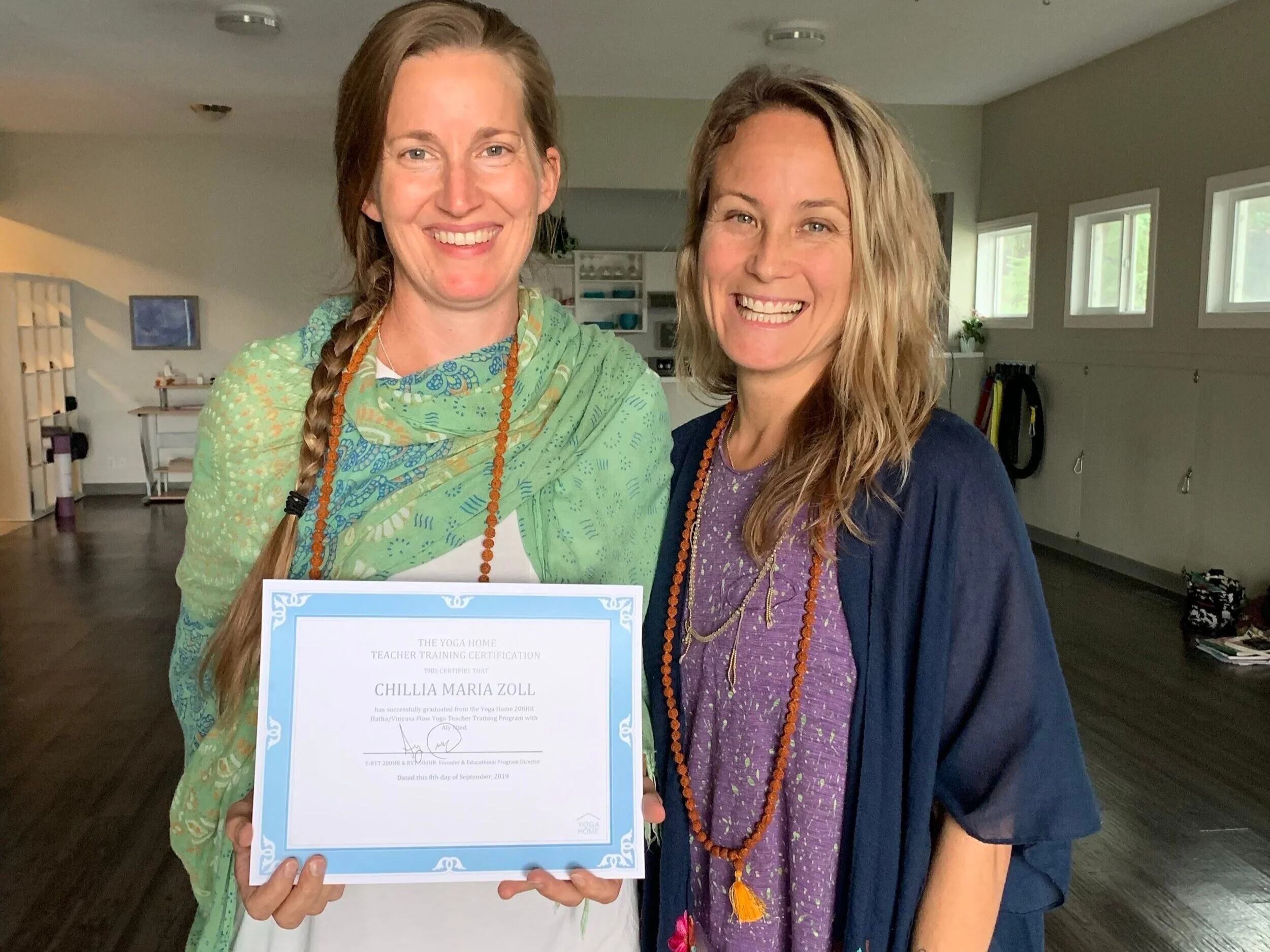 Aly Paws with a yoga teacher training graduate